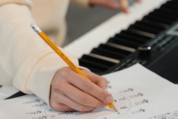 pexels-photo-6670748-6670748 Creating music sheets while playing piano. Perfect for education and creativity themes.